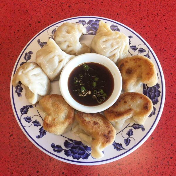 a plate of dumplings with soy sauce