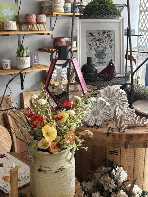 shelves and tables full of flower arrangements and other small trinkets